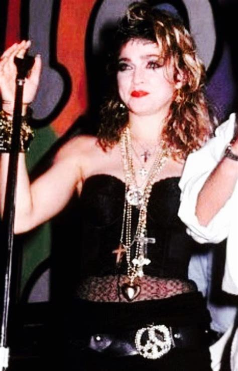 A Woman In A Black Corset Holding A Microphone