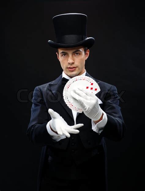 Magician showing trick with playing cards | Stock Photo | Colourbox