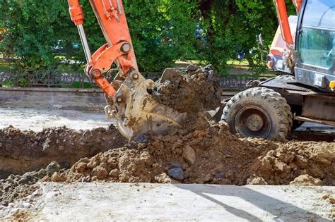 Premium Photo Excavator At Sandpit During Earthmoving Works Digs The Road