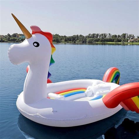 An Inflatable Unicorn Float Floating On The Water With A Rainbow Horn