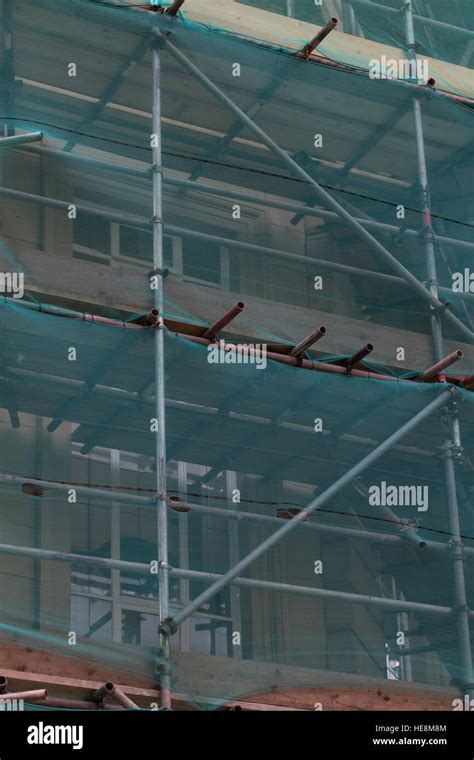 Scaffolding Frame Structure On Tall Building On Urban Street Stock