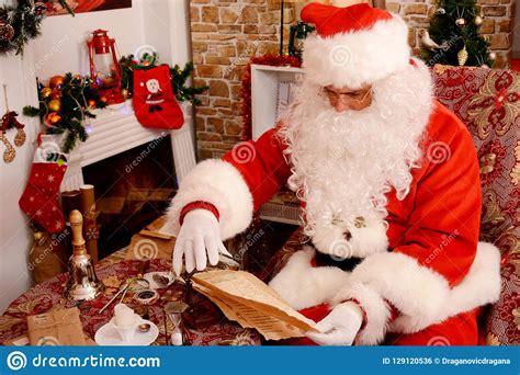 Santa Claus Preparing for Travel and Looking at the World Map Stock ...