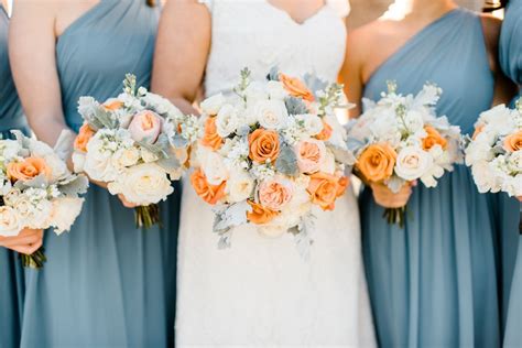 The Bridesmaids Are Holding Their Bouquets With Orange And White