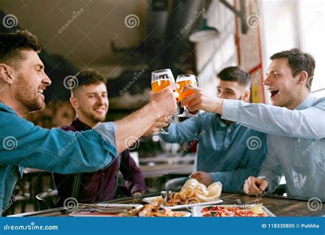 Men Drinking Beer in Pub stock image. Image of draught - 118330805