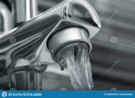 Water Flowing From Bath Tap On Blurred Background Closeup Stock Image