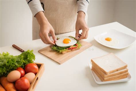 Hands Of Man Prepare Breakfast With Sandwich With Poached Eggs Stock Image Image Of Poached