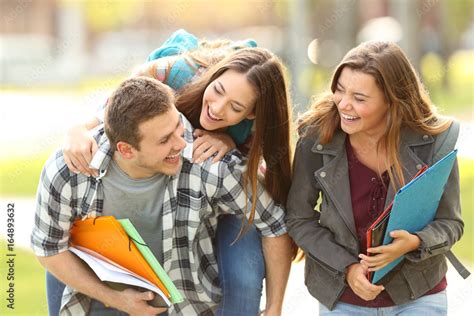 Happy students and friends in a campus Stock Photo | Adobe Stock