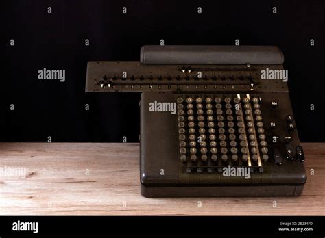 Old Counting Mechanism Dusty Vintage Arithmometer Standing On A Wooden