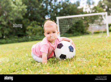 cute baby girl playing on grass with ball Stock Photo - Alamy