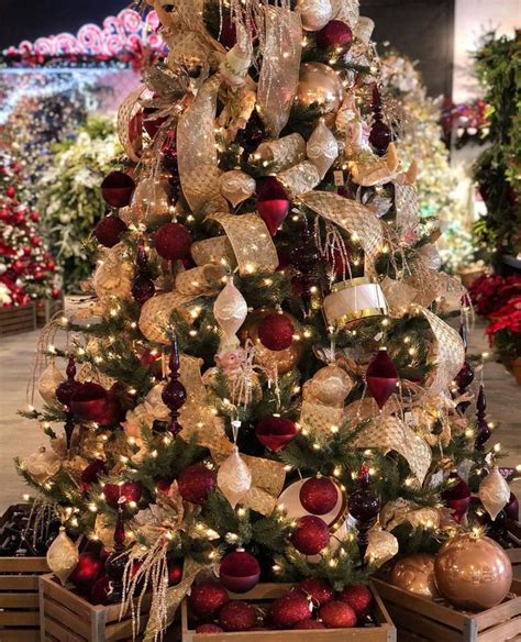 A Christmas Tree Is Decorated With Red And Gold Balls Ornaments And