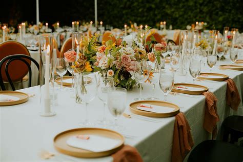 Long Dining Tables With Orange Chargers Taper Candles Low