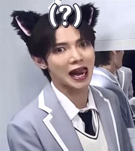 A Man In A Suit And Cat Ears On His Head