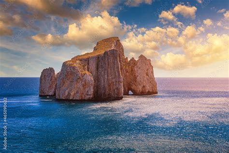 High cliffs of Mediterranean coast, "Pan di Zucchero" stack rock in Masua, west coast of ...