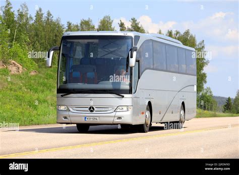 Silver Mercedes Benz Tourismo Coach Bus On Road On A Sunny Day Of