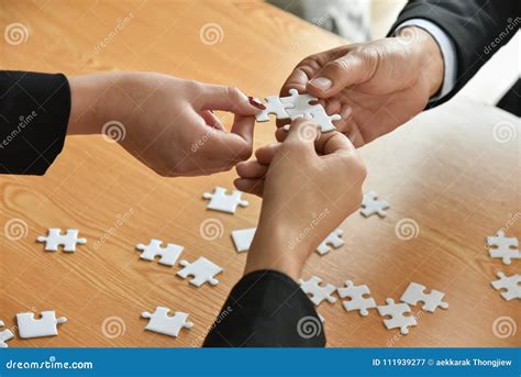 Group Of Business People Hands Are Connecting Jigsaw Puzzle Stock