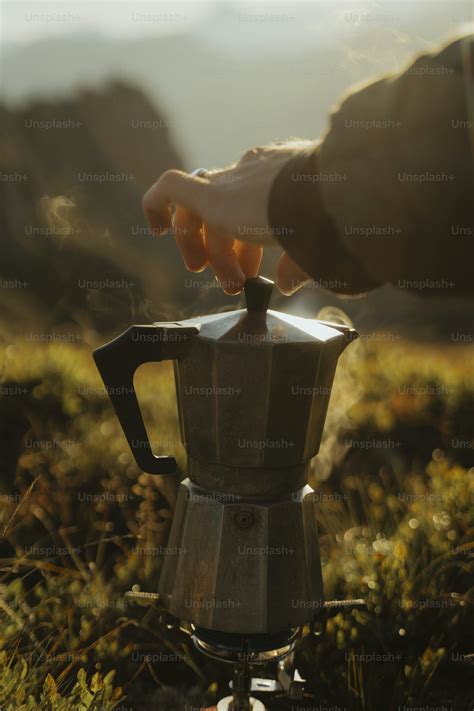 person  putting    coffee pot photo alps image