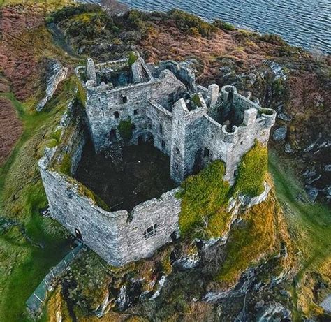 an aerial view of a castle near the water