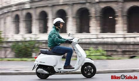 Picture Showing The Side View Of A Guy Riding The Vespa S 125 Vespa