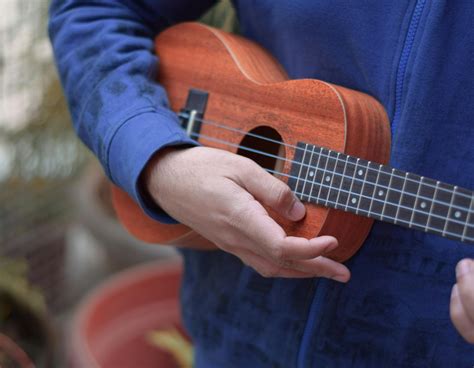 Person Playing Brown Ukulele · Free Stock Photo