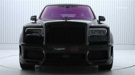 The Front End Of A Black Rolls Royce Parked In A Room With White Walls