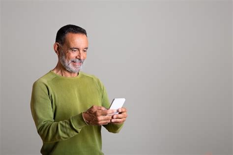 Premium Photo Glad Mature European Man Chatting On Smartphone In Social Networks Isolated