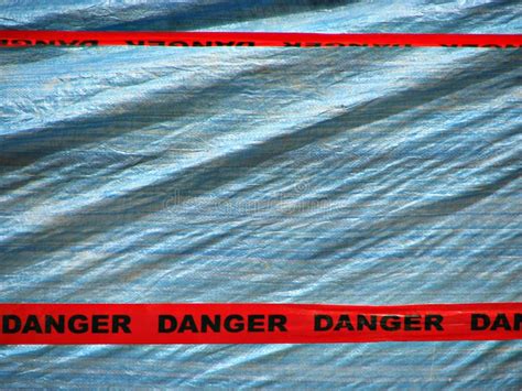 Red Danger Tape Over a Blue Wall Background Stock Image - Image of ...