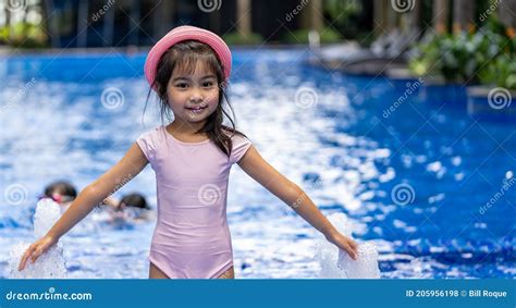 Portrait Of Pretty Asian Child Smilling And Posing On Swimming Pool