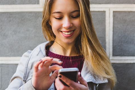 Teenage Girl Texting On A Mobile Phone By Stocksy Contributor