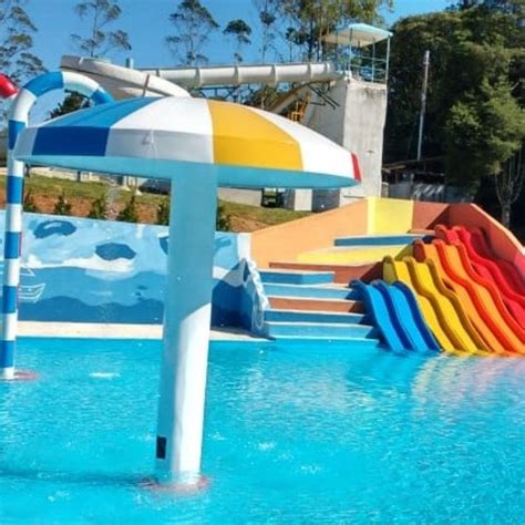 An Inflatable Water Slide Next To A Pool Filled With Blue Yellow And