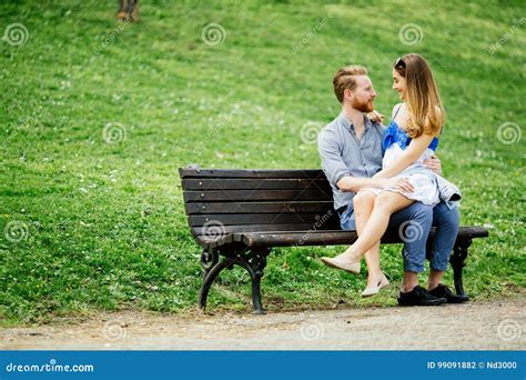 Dating Couple Sitting On Bench Stock Photo Image Of Seasonal Lovers