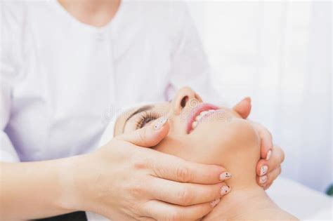 Cropped Photo Of Beautician Makes A Facial Massage Procedure To A