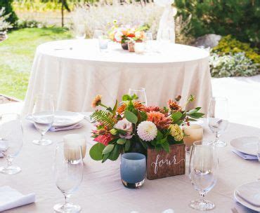 the table is set with flowers and place settings