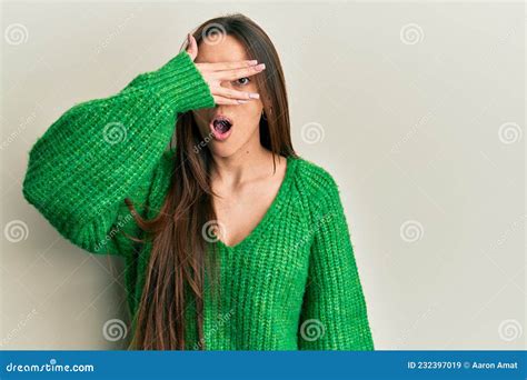 Young Hispanic Girl Wearing Casual Clothes Peeking In Shock Covering