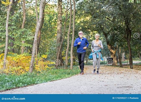 Old Couple Of Pensioners Running In Park Stock Image Image Of Fitness