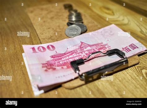Restaurant change with 100 New Taiwan dollar bank note and coins in a ...
