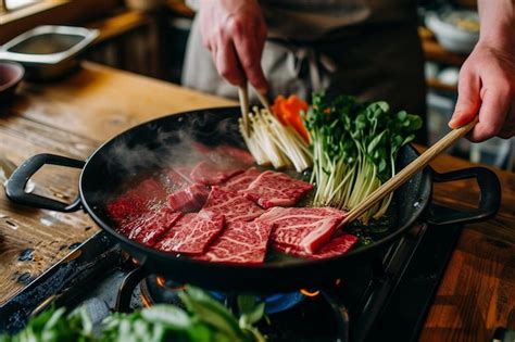 Premium Photo Man Holding Rare Slice Wagyu A Beef Into Shabu Hot Pot Shoyu Soup Base