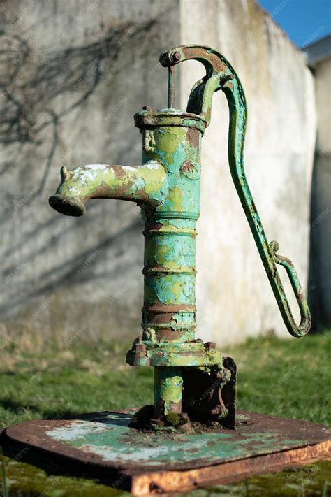 Premium Photo | Old hand water pump on a well in the garden watering and saving water rural ...