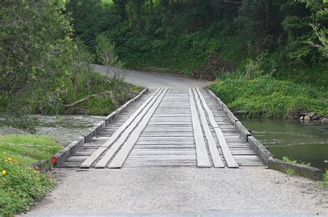 A Small Wooden Bridge Across A Stream Nature And Outdoors