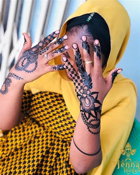 A Woman With Henna Tattoos On Her Hands