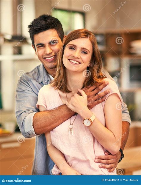 Happiest When Were Together Portrait Of An Affectionate Young Couple Standing In Their Kitchen