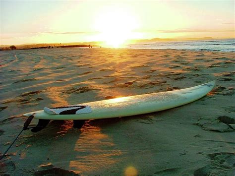 Surfboards On The Beach At Sunset