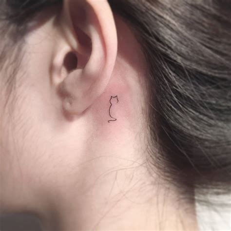 Tattoo Of A Cat Located Behind The Ear Minimalistic