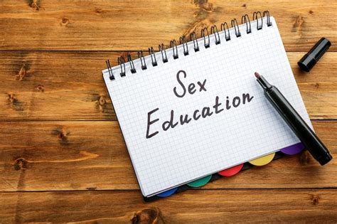 Premium Photo Exercise Book With Text Sex Education On Wooden Background