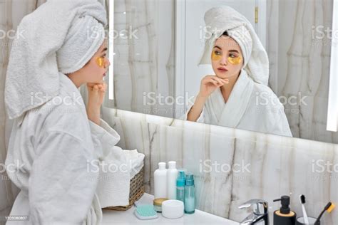 Beautiful Woman With Eye Patches In White Bathrobes In Bathroom Stock