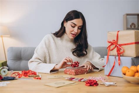 Premium Photo Woman Wrapping Christmas Presents Gifts