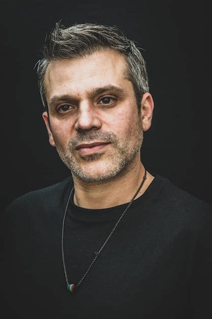 Premium Photo Close Up Of Thoughtful Mature Man Against Black Background