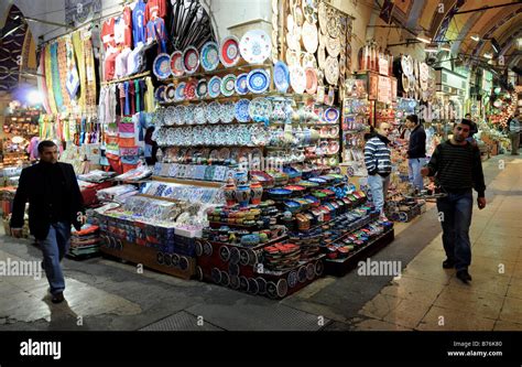 Two Local Turkish Men Walk Through The Colourful Alleyways Of The Grand