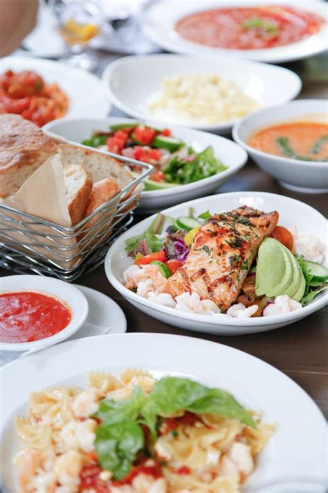 Assorted Entrees, Salmon Plate, House Bread, Salad, Pasta Stock Photo ...