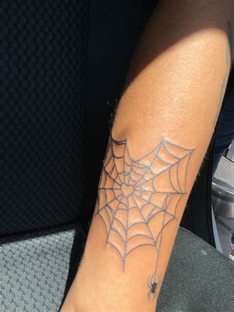 a person with a spider web tattoo on their arm