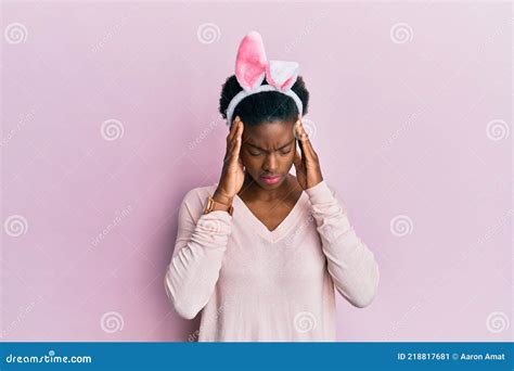 Young African American Girl Wearing Cute Easter Bunny Ears With Hand On